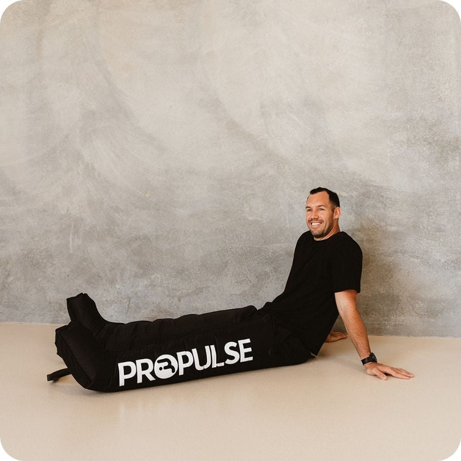 Man lying down wearing PROPulse compression boots