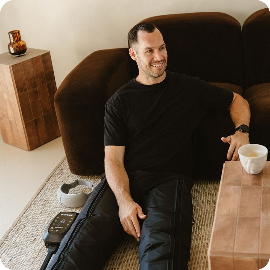Man recovering on the couch in PROPulse compression boots