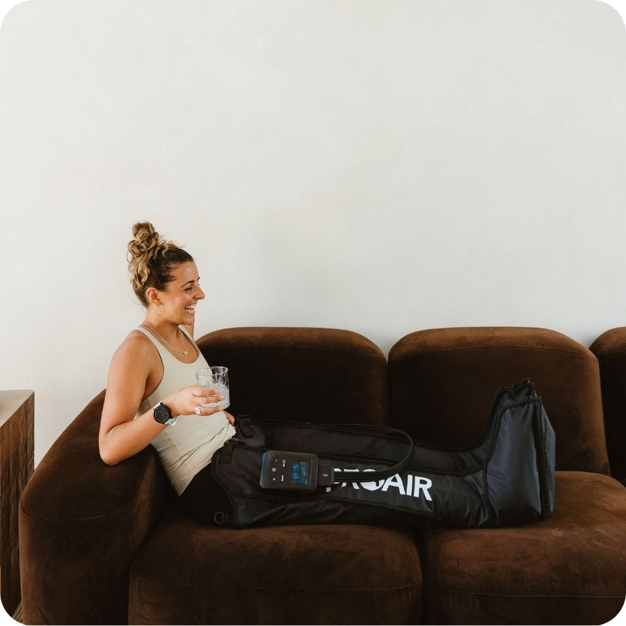 Woman relaxing in PROAir Wireless compression boots with no hoses